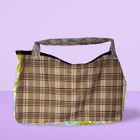 a plaid tote bag on a purple background